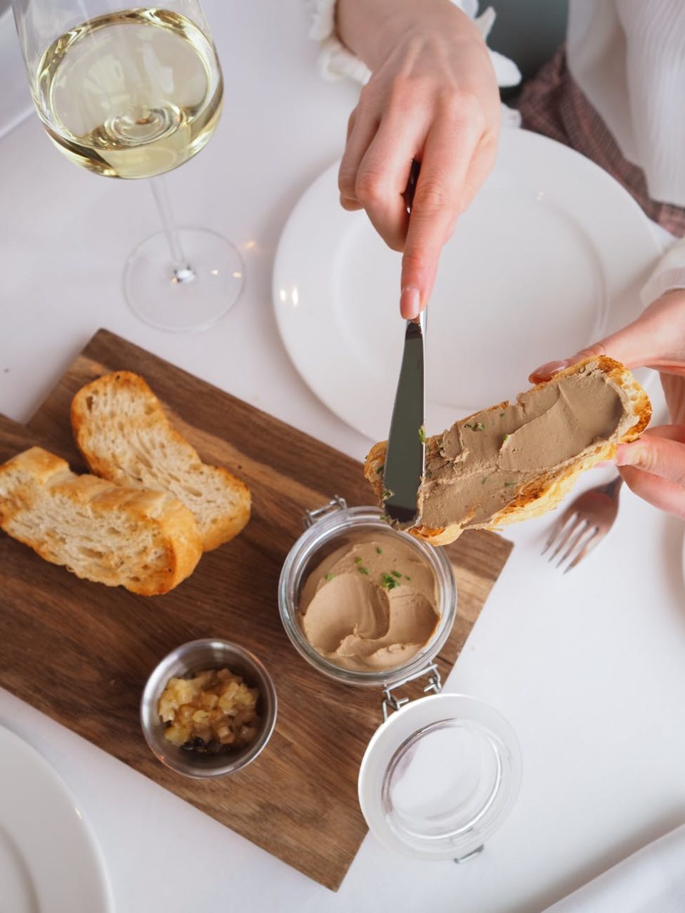 woman having a meal and a glass of wine