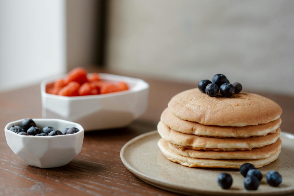pancakes with berries on ceramic plate